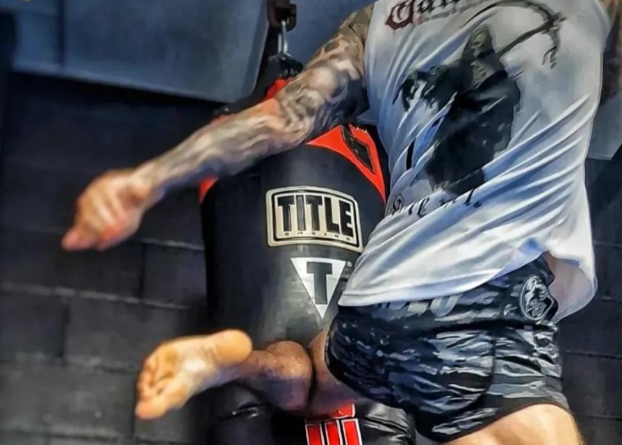 Person training on a Title punching bag with 'Gallantry' branding.